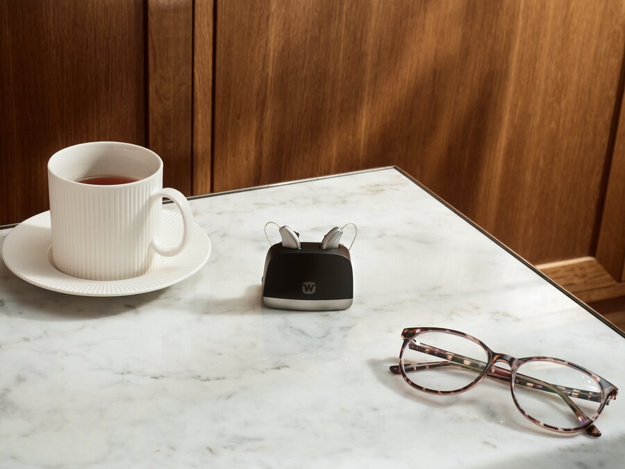 Table with charger and Aids Image of Widex hearing system